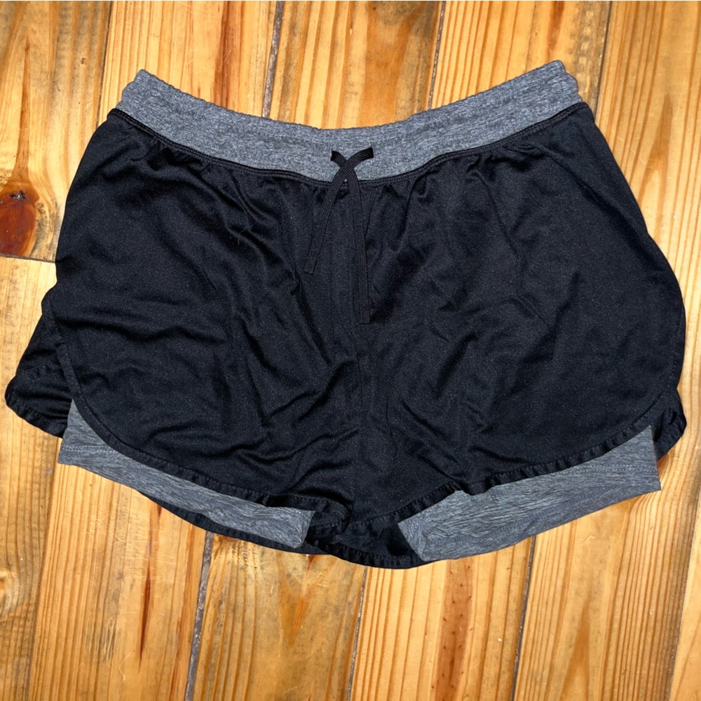 Black Champion athletic shorts with gray shorts inside.